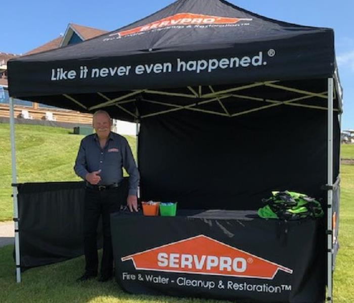 black event tent with male standing by table